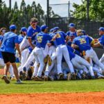 Lander baseball players celebrate after winning their first NCAA Tournament game in nine years during the 2025 DII Southeast Regional.