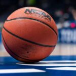 NCAA basketball teams with "32-game season approved for 2026–27" headline