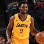 Bronny James dribbling the ball in a Lakers jersey during the 2025 NBA Summer League game.