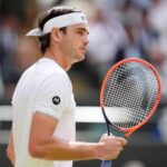 Taylor Fritz in action during Wimbledon 2025, preparing to serve in his quarterfinal match against Karen Khachanov.