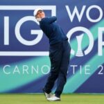 Golfers compete at Royal Porthcawl during the 2025 AIG Women’s Open, with fans watching from the sidelines under a cloudy Welsh sky